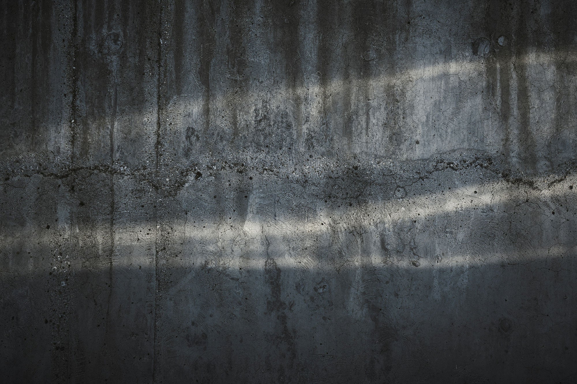 Decorative: A photo of a concrete wall, being used as a background texture, subtly indicating barriers